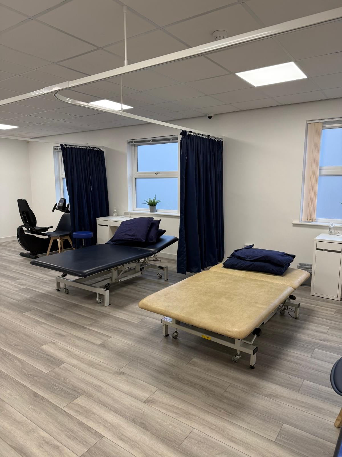 Modern physiotherapy treatment room with cubicle curtains